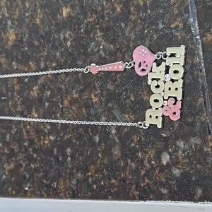 A 2000s vintage, hard rock, cafe rock and roll necklace
